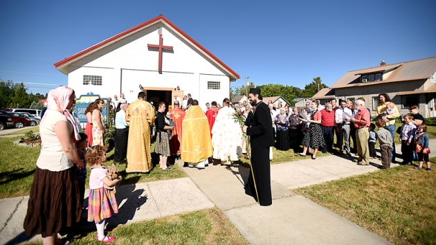 Bishop Maxim of the Serbian Orthodox diocese of Western America is greeting by the crowd gathered outside Saint Herman Orthodox Church in Kalispell on Sunday, July 19, for the blessing of the temple and the ordination of the Rev. Daniel Kirk, the first priest to serve at Saint Herman and the first Orthodox priest to be ordained in the state of Montana. (Brenda Ahearn/Daily Inter Lake)